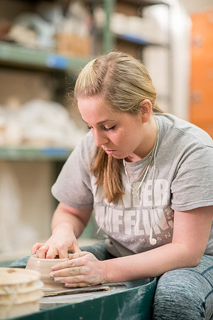Students work on their clay projects in beginning ceramics class.