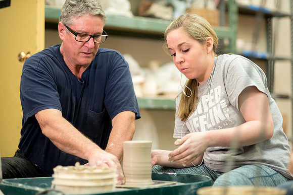 Students work on their clay projects in beginning ceramics class.