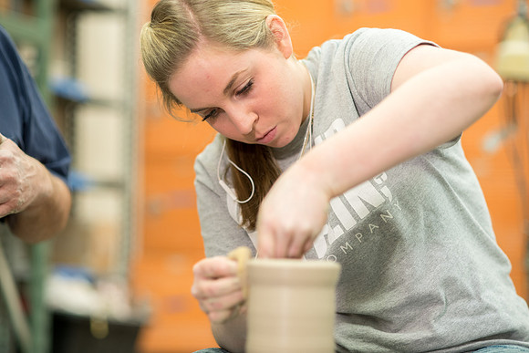 Students work on their clay projects in beginning ceramics class.