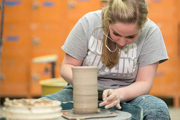 Students work on their clay projects in beginning ceramics class.