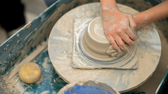 Students work on their clay projects in beginning ceramics class.