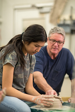 Students work on their clay projects in beginning ceramics class.