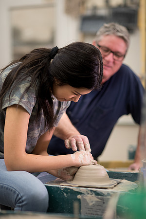 Students work on their clay projects in beginning ceramics class.