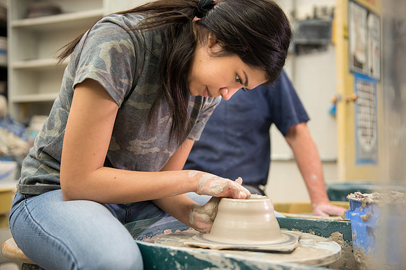Students work on their clay projects in beginning ceramics class.