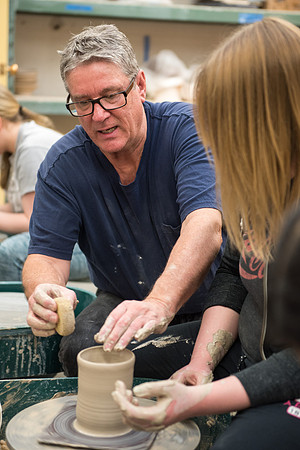 Students work on their clay projects in beginning ceramics class.