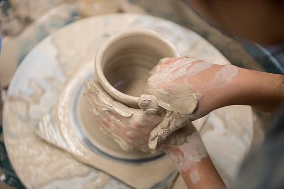 Students work on their clay projects in beginning ceramics class.