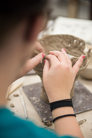 Students work on their clay projects in beginning ceramics class.