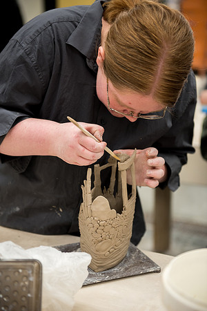 Students work on their clay projects in beginning ceramics class.