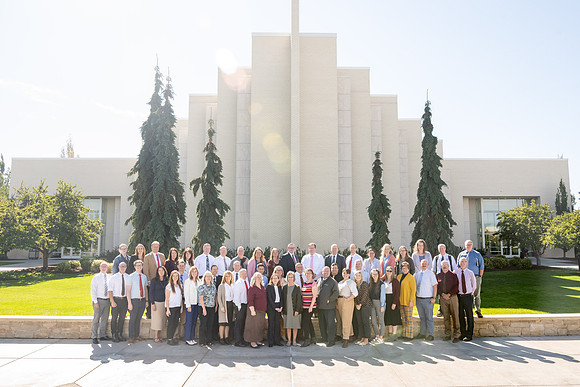 Employees of the online learning group stand outside the Taylor Building for a group photo.