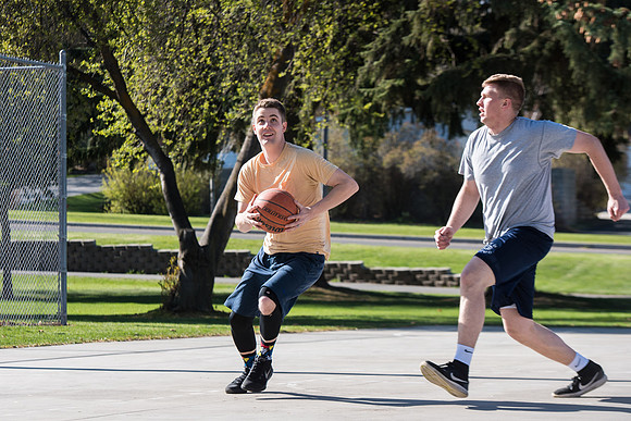 Jacob and Jacob, two BYU-Idaho students, play one on one basketball at the Smith Park court.