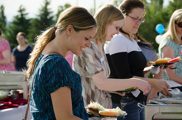 Online instructors gather with their families for an eveing of BBQ and games.