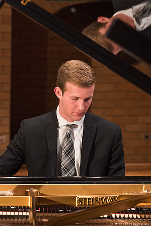 Doug Rowen, a music major, plays the Hamburg Steinway Piano in the Barrus Hall. 2018