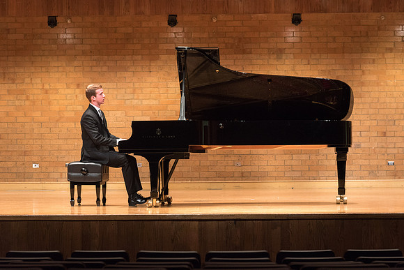 Doug Rowen, a music major, plays the Hamburg Steinway Piano in the Barrus Hall. 2018