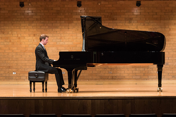 Doug Rowen, a music major, plays the Hamburg Steinway Piano in the Barrus Hall. 2018