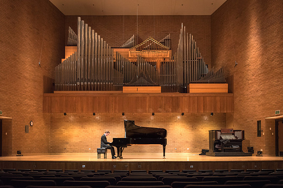 Doug Rowen, a music major, plays the Hamburg Steinway Piano in the Barrus Hall. 2018