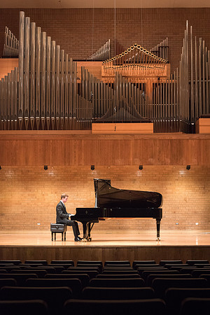 Doug Rowen, a music major, plays the Hamburg Steinway Piano in the Barrus Hall. 2018