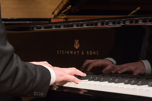 Doug Rowen, a music major, plays the Hamburg Steinway Piano in the Barrus Hall. 2018