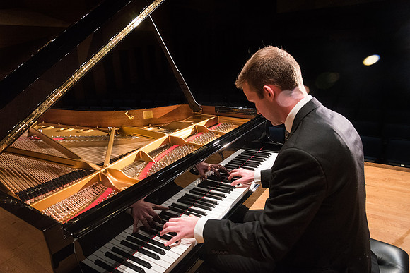 Doug Rowen, a music major, plays the Hamburg Steinway Piano in the Barrus Hall. 2018