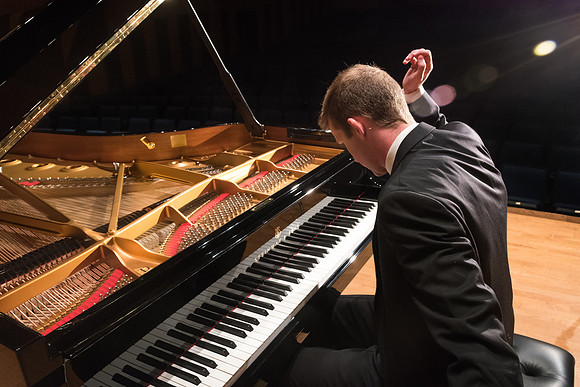 Doug Rowen, a music major, plays the Hamburg Steinway Piano in the Barrus Hall. 2018