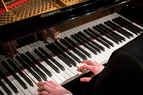 Doug Rowen, a music major, plays the Hamburg Steinway Piano in the Barrus Hall. 2018