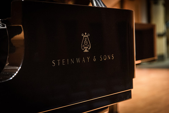 Doug Rowen, a music major, plays the Hamburg Steinway Piano in the Barrus Hall. 2018