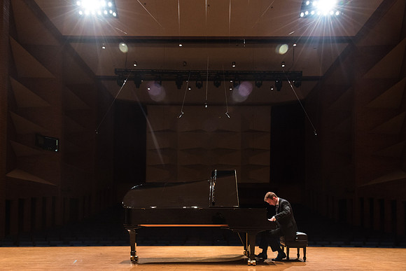 Doug Rowen, a music major, plays the Hamburg Steinway Piano in the Barrus Hall. 2018
