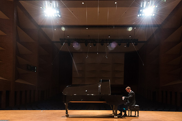 Doug Rowen, a music major, plays the Hamburg Steinway Piano in the Barrus Hall. 2018
