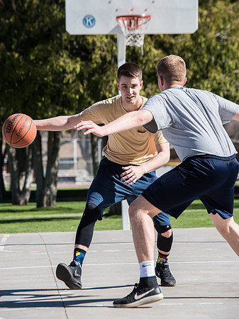 Jacob and Jacob, two BYU-Idaho students, play one on one basketball at the Smith Park court.
