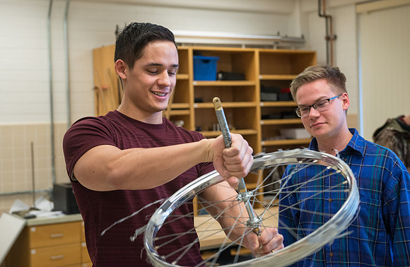 Physics students learn about rotational forces in a lab.