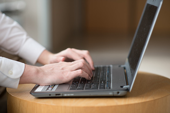 Online student using laptop computer.