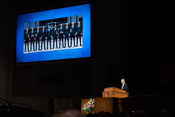 Elder Nattress, General Authority Seventy, uses photos of President Henry J. Eyring in his devotional talk.