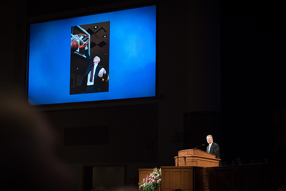 Elder Nattress, General Authority Seventy, uses photos of President Henry J. Eyring in his devotional talk.