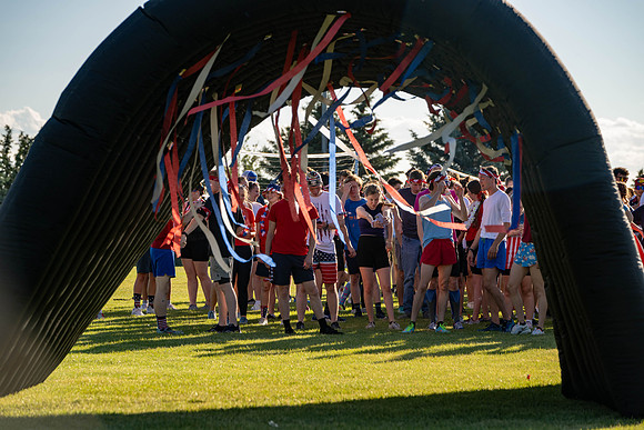 Students gather at the upper field for various 4th of July activities.