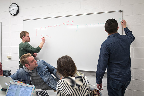 Students study with Brother John Fisher in the Biology Study Lab.
