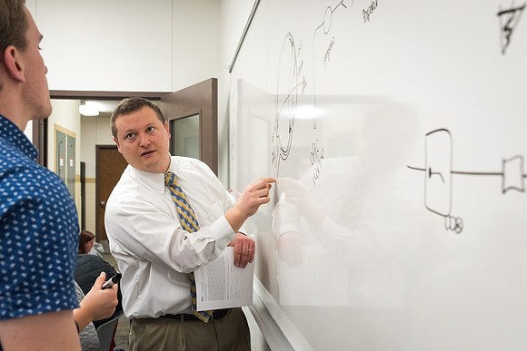 Students study with Brother John Fisher in the Biology Study Lab.