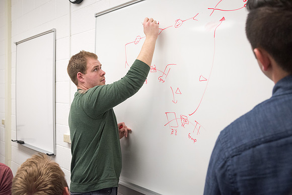 Students study with Brother John Fisher in the Biology Study Lab.