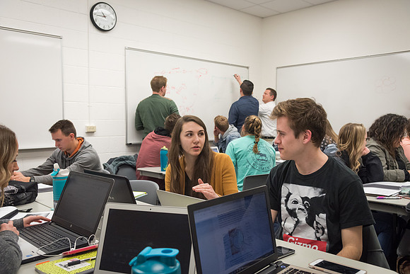 Students study with Brother John Fisher in the Biology Study Lab.