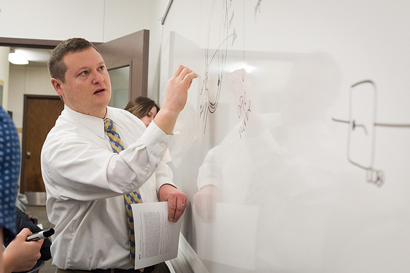 Students study with Brother John Fisher in the Biology Study Lab.