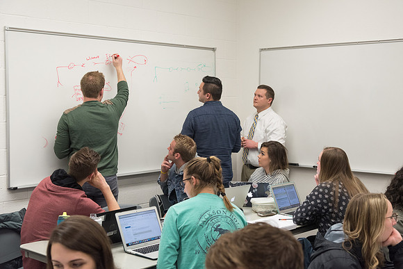 Students study with Brother John Fisher in the Biology Study Lab.