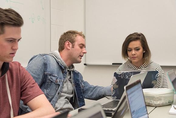 Students study with Brother John Fisher in the Biology Study Lab.