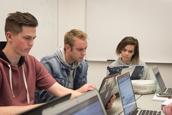 Students study with Brother John Fisher in the Biology Study Lab.