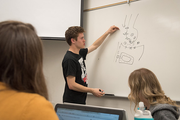 Students study with Brother John Fisher in the Biology Study Lab.