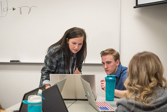 Students study with Brother John Fisher in the Biology Study Lab.