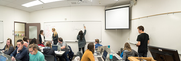 Students study with Brother John Fisher in the Biology Study Lab.