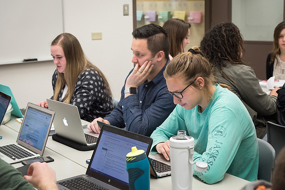 Students study with Brother John Fisher in the Biology Study Lab.