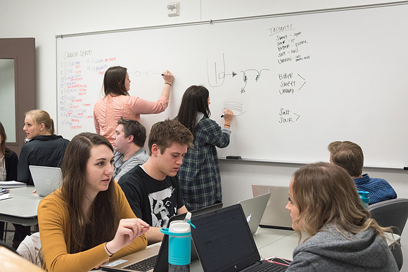 Students study with Brother John Fisher in the Biology Study Lab.