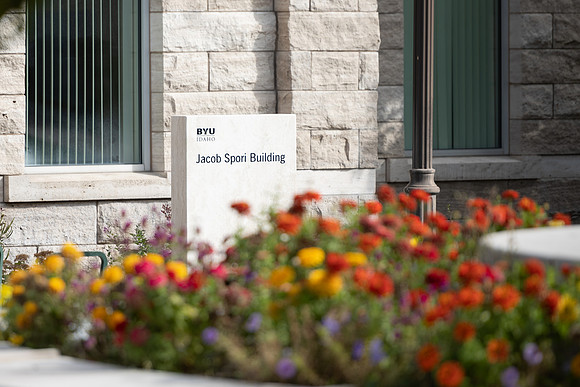 Spori Building sign with flowers.