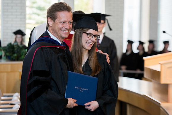 Rob Eaton, Assoicate Academic Vice President gave diploma to his daughter at the College of Eduation and Human Development convocation.