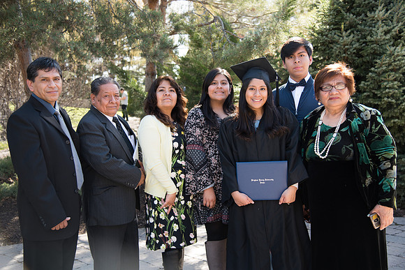 BYU-Idaho Winter Semester Graduation. A graduate poses with her family visiting from Peru. Apr 2018
