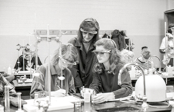 Chemistry teacher, Susan Ward, works with students during their Chemistry lab. December 1995.